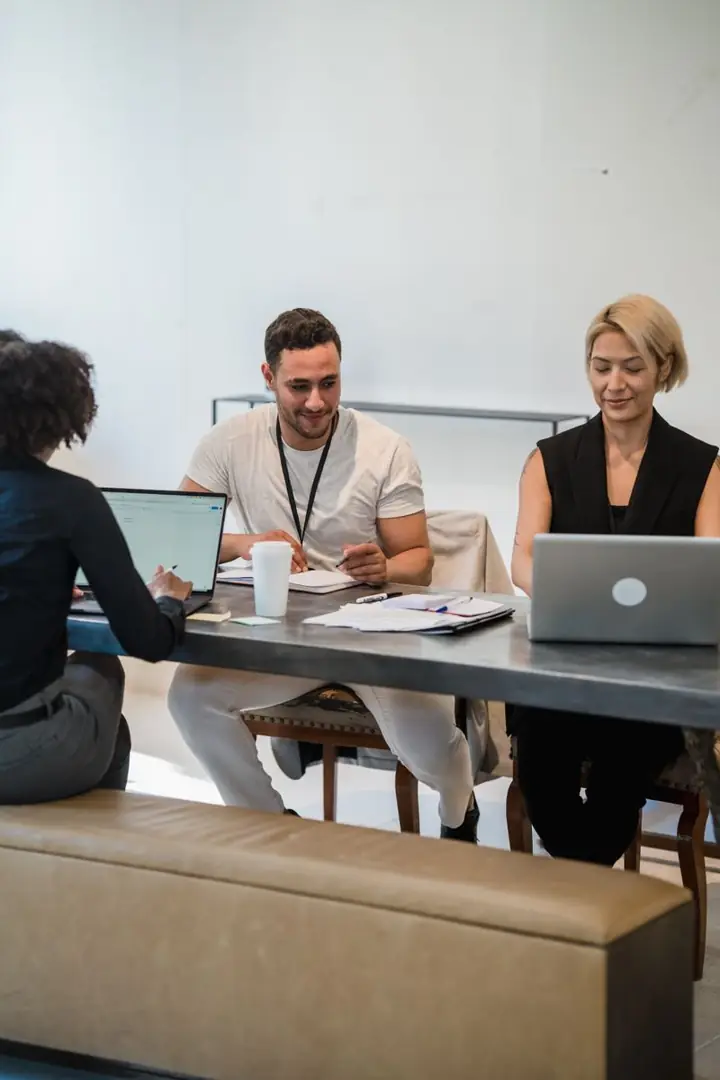 A team working together at laptops in an office